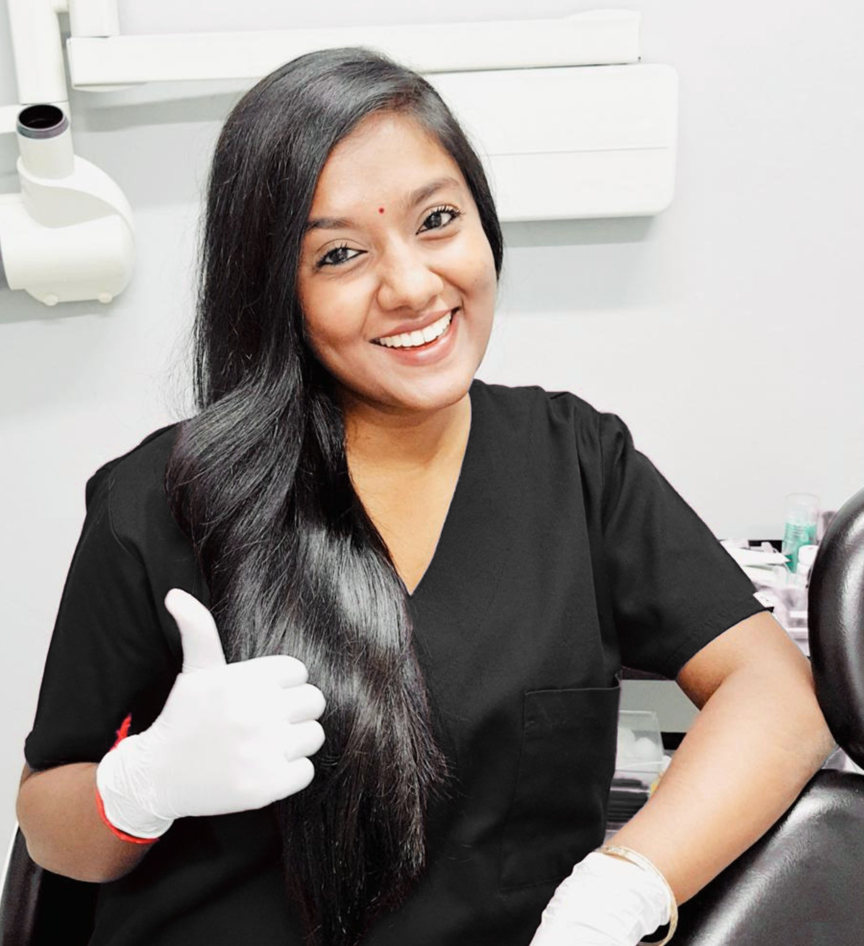 Dr Yavini Naidoo smiling in her dental practice